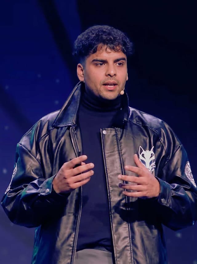 Daksh Joshi, technology and systems instructor, presenting on stage