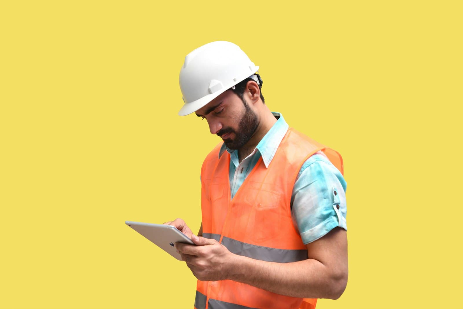 A safety engineer reviewing site documentation on a tablet